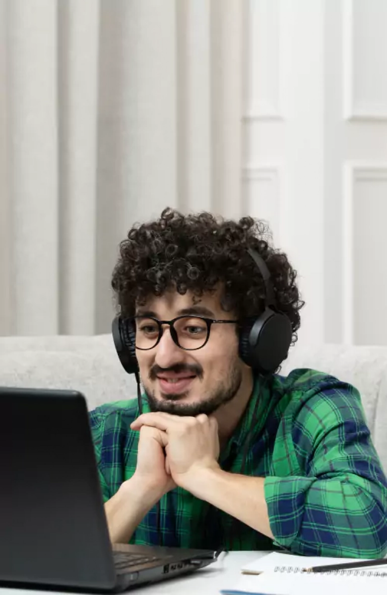 A man looking at laptop and smiling